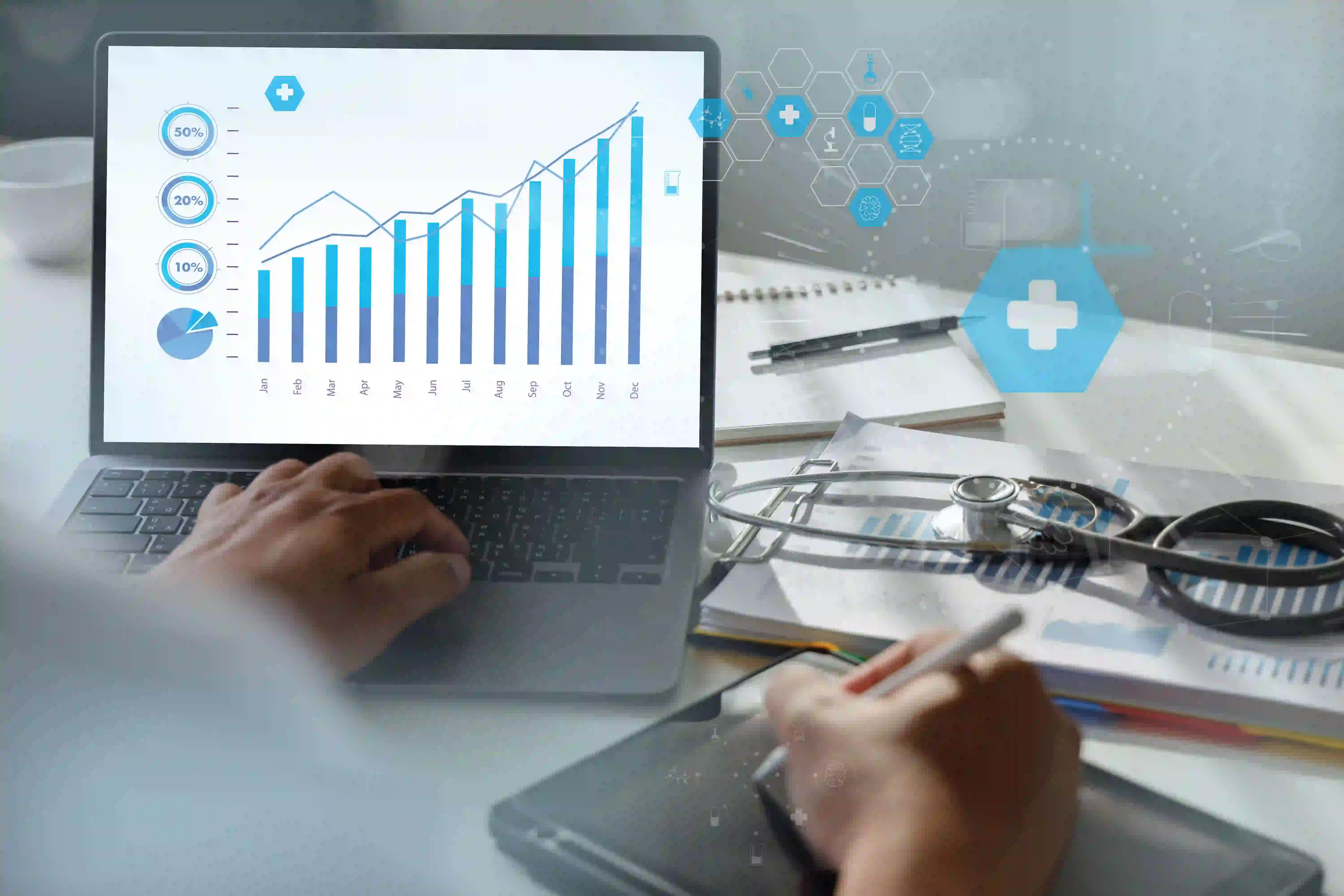 A person is working on a laptop displaying a bar chart with rising data points. Nearby, there are documents, a stethoscope, and hexagon icons symbolizing medical and technological concepts, indicating analysis or reporting in a medical or healthcare setting, possibly involving Medical Billing Software